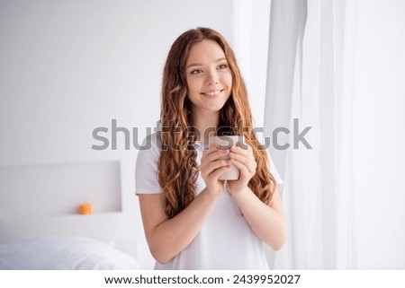 Photo of pretty cheerful female person toothy smile hands hold fresh coffee mug look window inspiration pastime bedroom flat indoors
