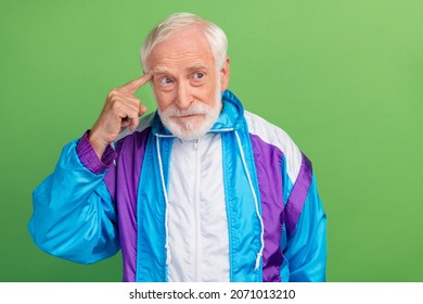 Photo Of Pretty Confused Senior Man Wear Sportive Suit Finger Head Forget Important Thing Looking Empty Space Isolated Green Color Background