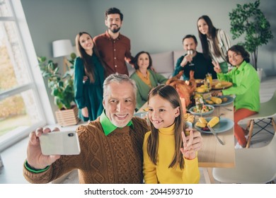 Photo of pretty cute family eating holiday turkey sitting table showing v-sign recording video modern device indoors house room - Powered by Shutterstock