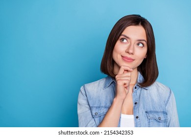 Photo of pretty dreamy lady dressed denim shirt hand chin looking empty space isolated blue color background - Powered by Shutterstock