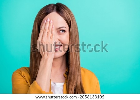 Photo of pretty dreamy mature lady wear yellow shirt arm close eye looking empty space smiling isolated turquoise color background