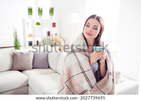 Photo of pretty dreamy young woman dressed green shirt sitting couch cover blanket drinking coffee indoors house home room