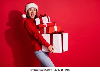 Photo of pretty excited young lady dressed print pullover holding new year presents isolated red color background - Powered by Shutterstock