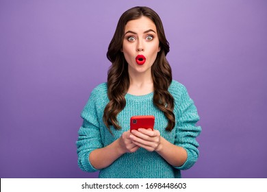 Photo of pretty funny excited lady red lipstick curly hairdo open mouth hold telephone post youth blog read comments wear blue pullover isolated purple color background