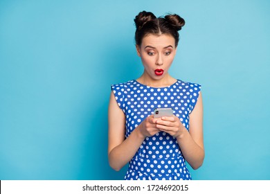 Photo of pretty funny lady open mouth hold telephone hands check comments new post see bad negative words wear dotted white blouse shirt isolated blue color background