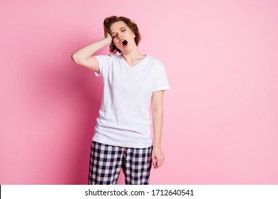 Photo of pretty funny tired lady hold hand on head sleepy morning eyes closed don't want go work wear white t-shirt plaid pajama pants isolated pink color background
