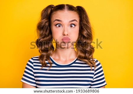 Photo of pretty funny young lady dressed striped outfit pouted lips bloated cheeks isolated yellow color background