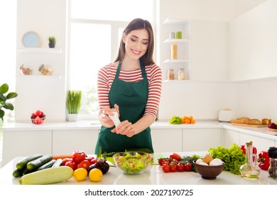 Photo Of Pretty Happy Positive Young Woman Hold Salt Make Salad Health Food Wear Apron Indoors Inside Kitchen