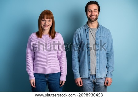 Photo of pretty lady and handsome guy couple one team members reliable workers posing isolated over blue color background 