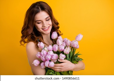 Photo of pretty lady holding big bunch of pink tulips in hands wear tank-top isolated yellow background - Powered by Shutterstock