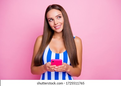 Photo Of Pretty Lady Long Straight Hairdo Hold Telephone Blogger Writing Blog Post About Exotic Resort Wear White Blue Striped Bodysuit Isolated Pastel Pink Color Background