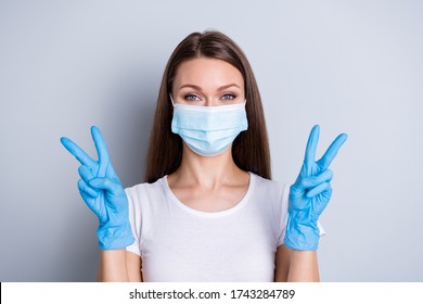 Photo of pretty lady show v-sign symbols hands gloves keep social distance had hospital examination healthy person meet friends wear protect face medical mask isolated grey color background