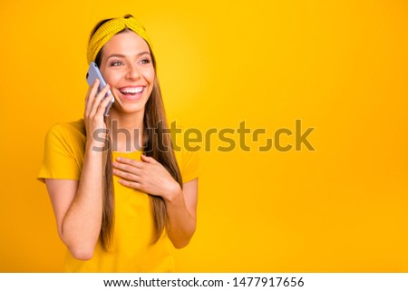 Photo of pretty lady speaking over telephone telling humorous novelty wear casual t-shirt isolated yellow background