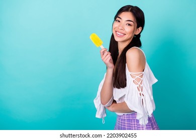 Photo Of Pretty Lovely Lady Enjoying Summer Holiday Hold Fruity Popsicle Frozen Yogurt Isolated Cyan Color Background