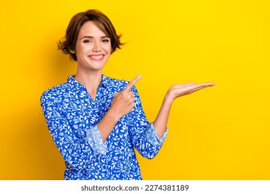 Photo of pretty lovely lady wear trendy clothes arm demonstrate empty space banner interesting news isolated on yellow color background - Shutterstock ID 2274381189
