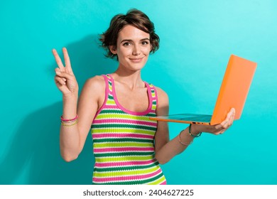 Photo of pretty nice person hold wireless laptop demonstrate v-sign isolated on teal color background