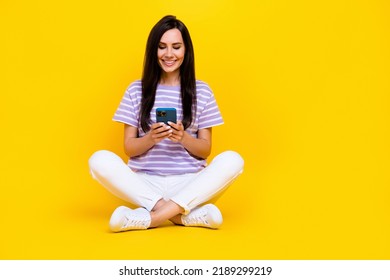 Photo Of Pretty Positive Lady Sit Legs Crossed Use Device Write Typing Post Instagram Followers Empty Space Isolated On Yellow Background