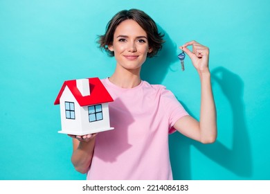 Photo of pretty satisfied person arm demonstrate present show little house hold key new build isolated on aquamarine color background