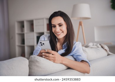 Photo of pretty shiny lady dressed blue shirt texting apple iphone samsung modern gadget indoors house room - Powered by Shutterstock