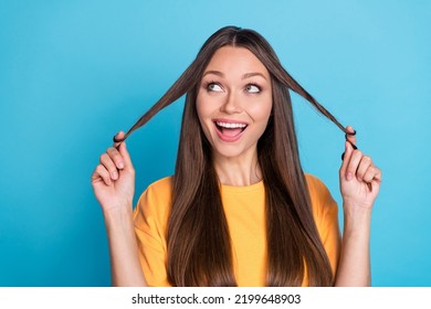 Photo Of Pretty Sweet Cute Lady Hand Arm Touch Strand Hair Eyes Up Interested Look Empty Space Isolated On Blue Color Background