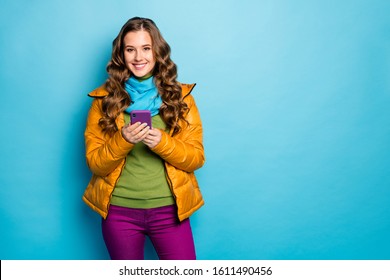 Photo of pretty traveler lady hold telephone search online maps best trip way information wear yellow overcoat scarf violet trousers green jumper isolated blue color background - Powered by Shutterstock