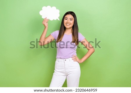 Photo of pretty vietnamese chinese young girl hold paper speech cloud dressed stylish violet outfit isolated on green color background