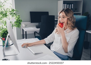 Photo of pretty young girl bite eating apple lunch wear formalwear coworking successful nice light office - Powered by Shutterstock