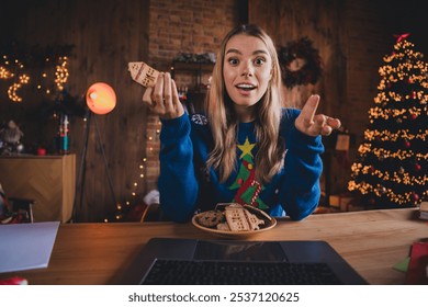 Photo of pretty young girl excited watch movie eat cookies video call wear christmas garment tradition atmosphere decor house indoors room - Powered by Shutterstock