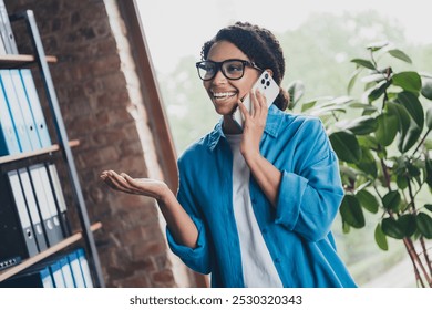 Photo of pretty young girl talk phone call wear blue shirt coworking programmer successful nice light office - Powered by Shutterstock