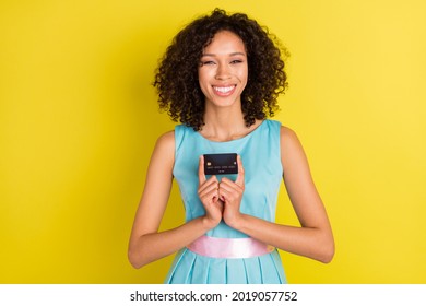 Photo Of Pretty Young Happy Afro American Woman Hold Hands Credit Card Smile Isolated On Yellow Color Background