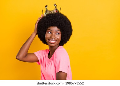 Photo of pretty young lady look empty space wear crown pink t-shirt isolated on yellow color background