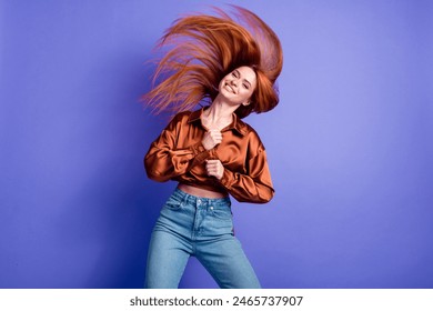 Photo of pretty young woman flying hair dancing wear brown shirt isolated on violet color background - Powered by Shutterstock