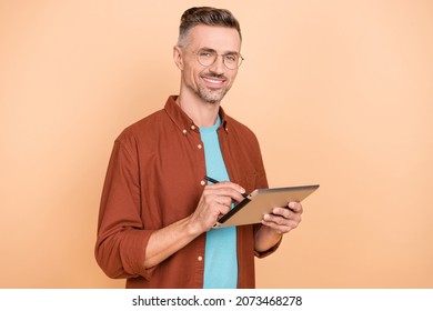 Photo of professional ceo guy hold application device draw sketches isolated over pastel beige color background - Powered by Shutterstock