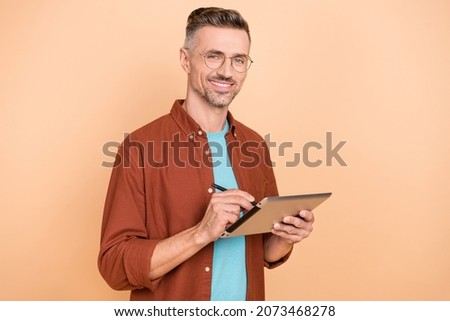 Photo of professional ceo guy hold application device draw sketches isolated over pastel beige color background