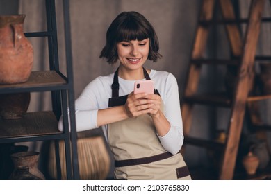 Photo of professional lady potter use smart device chatting client making present porcelain product vase in workroom - Powered by Shutterstock