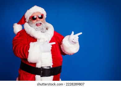 Photo of promoter pensioner funny man direct finger empty space wear santa hat costume isolated red color background - Powered by Shutterstock