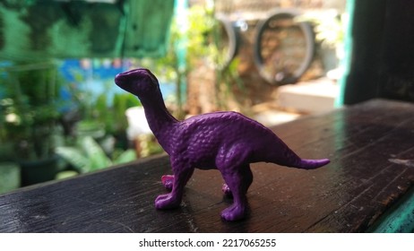 Photo Of A Purple Dinosaur Shaped Toy
