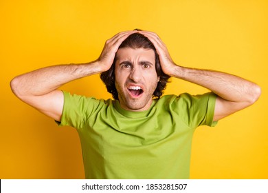 Photo Of Puzzled Loser Guy Palms Head Open Mouth Wear Green T-shirt Isolated Yellow Color Background