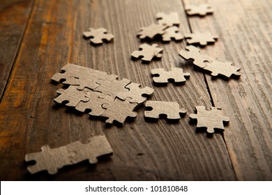 Photo puzzles scattered brown paper on the floor of wooden planks