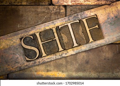 Photo of real authentic typeset letters forming capitalized SHTF text on vintage textured grunge copper background