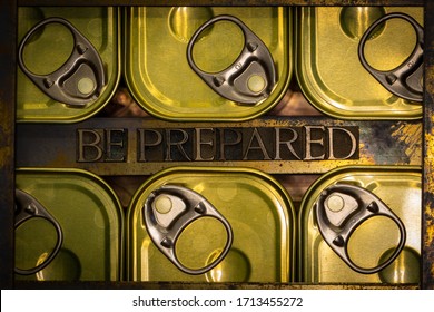Photo of real authentic typeset letters forming capitalized Be Prepared text between canned food flatlay on vintage textured grunge copper and gold background