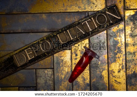 Photo of real authentic typeset letters forming Depopulation text with red fluid filled laboratory vial on vintage textured grunge copper background