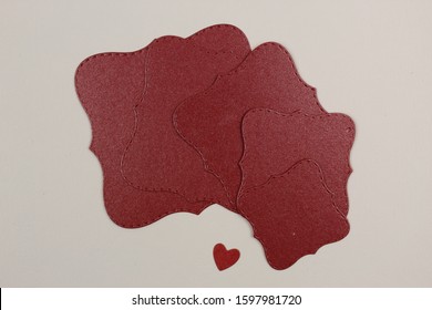 Photo of rectangular, red squares, on a white background, fan-laid.
