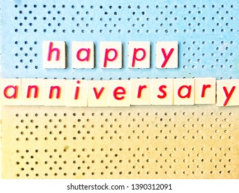 Photo Red Of Letters Spelt Happy Anniversary On Blue And Yellow Peg Board With Copy Space For Text For Cards