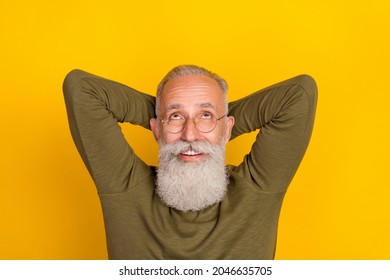 Photo of relaxed old man look up empty space dream wear eyewear green shirt isolated yellow color background