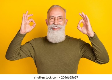 Photo of reliable handsome grandpa show okey signs wear glasses green shirt isolated yellow color background - Shutterstock ID 2046635657