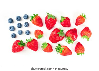 A photo of a representation of the American flag, made up by blueberries and strawberries on a white background. A culinary Independence Day greeting card, 4th of July banner