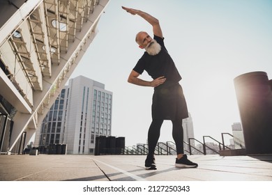 Photo of retired grandpa man prepare serious training warm up stretch body hand hip urban town outdoors