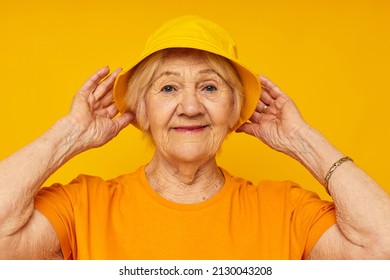 Photo Of Retired Old Lady In Yellow T-shirts Hat Posing Isolated Background