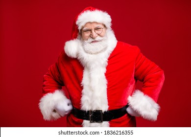 Photo of retired old man grey beard fists hips self-assured attend educate naughty kid play strict grandpa wear santa costume belt coat spectacles headwear isolated red color background - Powered by Shutterstock